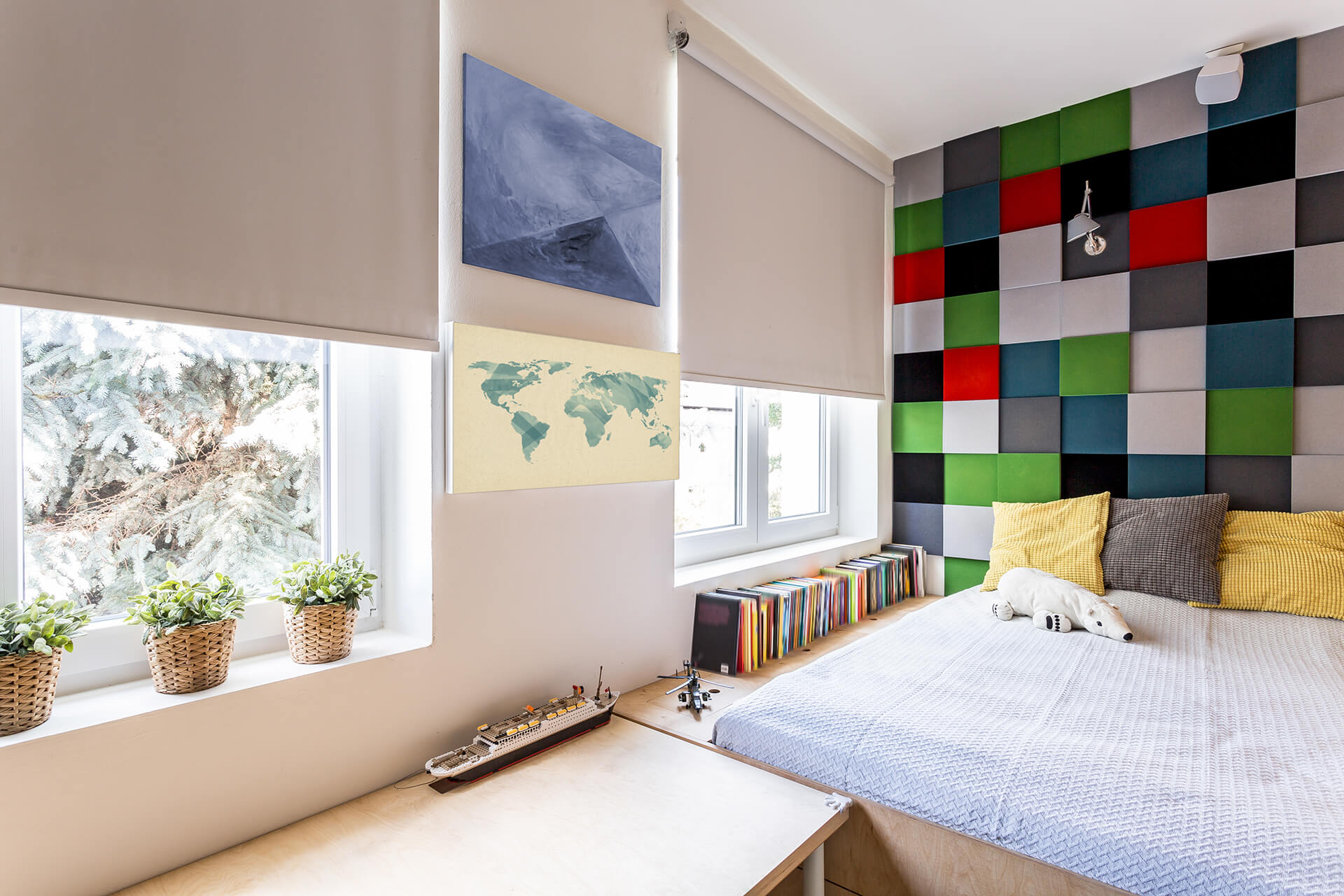A colorful kid's bedroom with gray roller shades on the windows.