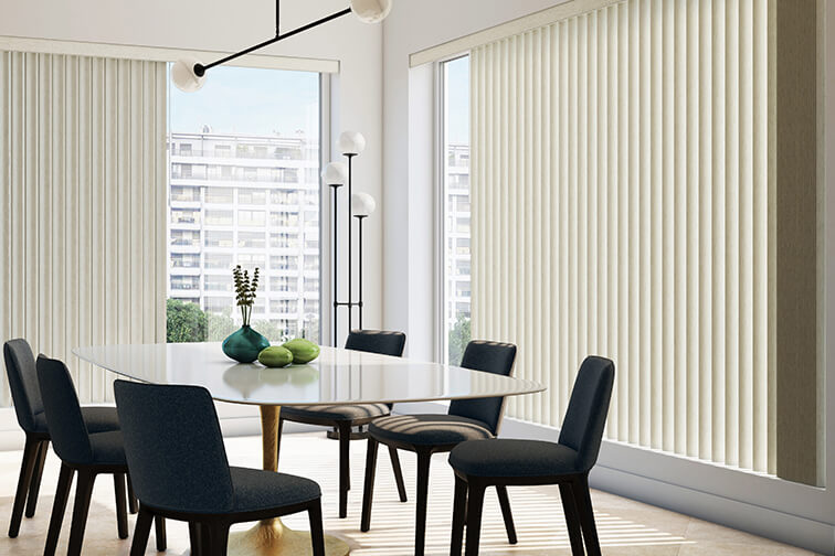 A modern dining room with vertical blinds half opened.