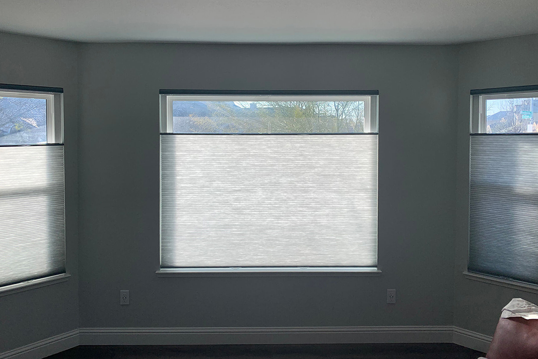 An empty room with reverse shades that open top to bottom.